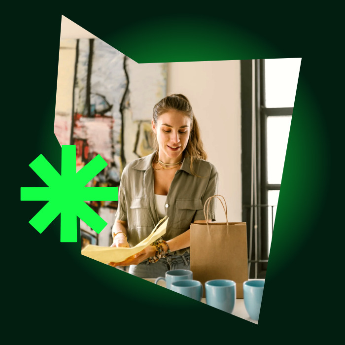 Woman unpacking a delivery in a bright studio