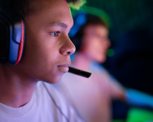 Developer wearing a headset, focused on a screen